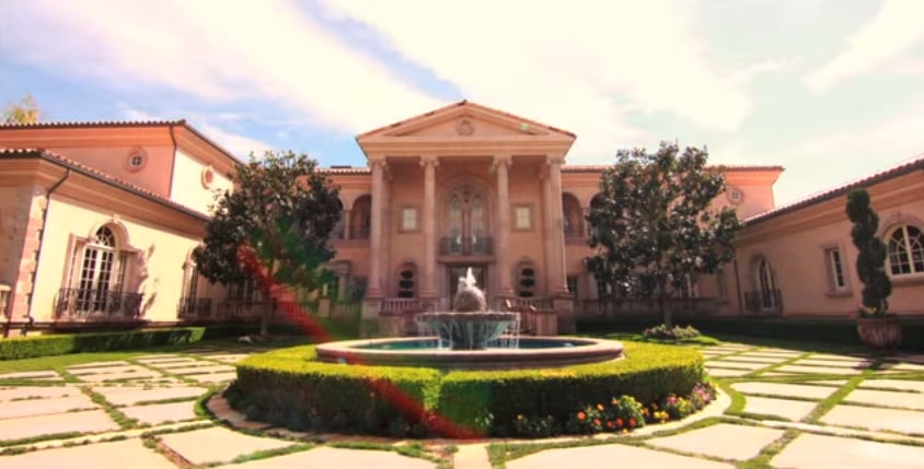 A driveway fountain and two-story entrance make quite a first impression.