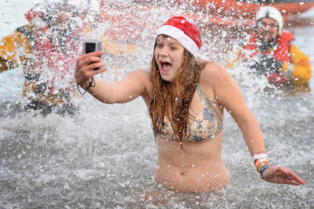 A girl snapped a selfie during the annual Loony Dook Swim in Scotland, where thousands of New Year's Day swimmers braved the cold.