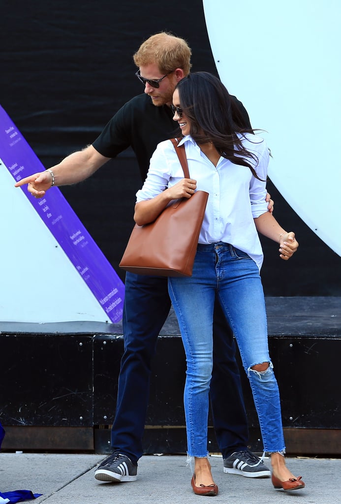 When Meghan attended the Invictus Games with Prince Harry in September 2017, she tucked a Misha Nonoo button-down into Mother Denim skinny jeans, and accessorized with neutral accessories, including an Everlane tote bag and Sarah Flint bow flats.
