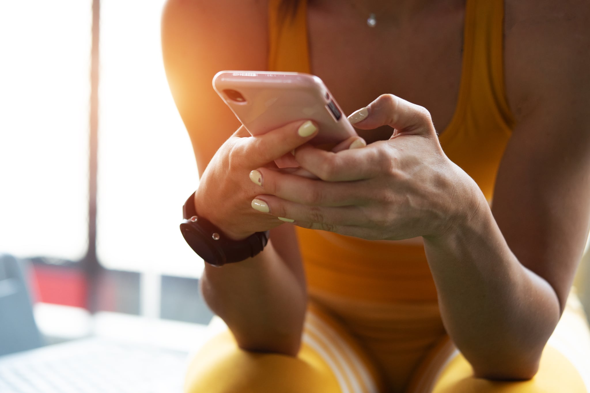 Young women in fitness clothes playing smartphone,playing smartphone