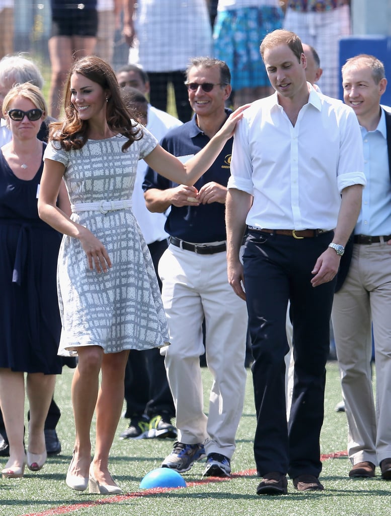 Kate Middleton put a hand on Prince William's shoulder while they visited Bacon's College in London in July 2012.