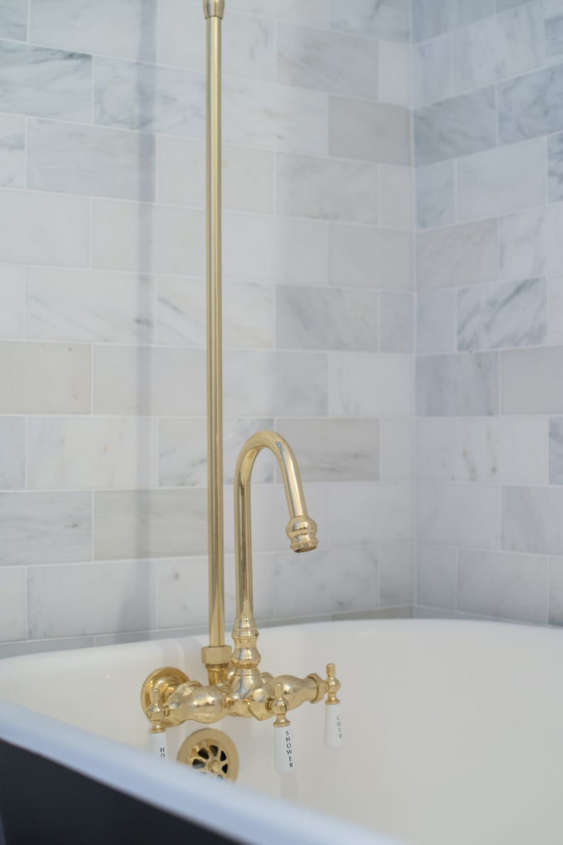 Black-and-White Bathroom With Brass Shower