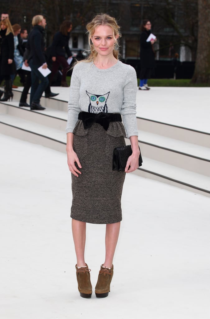 For the Burberry runway show in February 2012, Kate went head to toe in the brand, wearing a cheeky gray owl sweater tucked into a knee-length wool peplum pencil skirt.