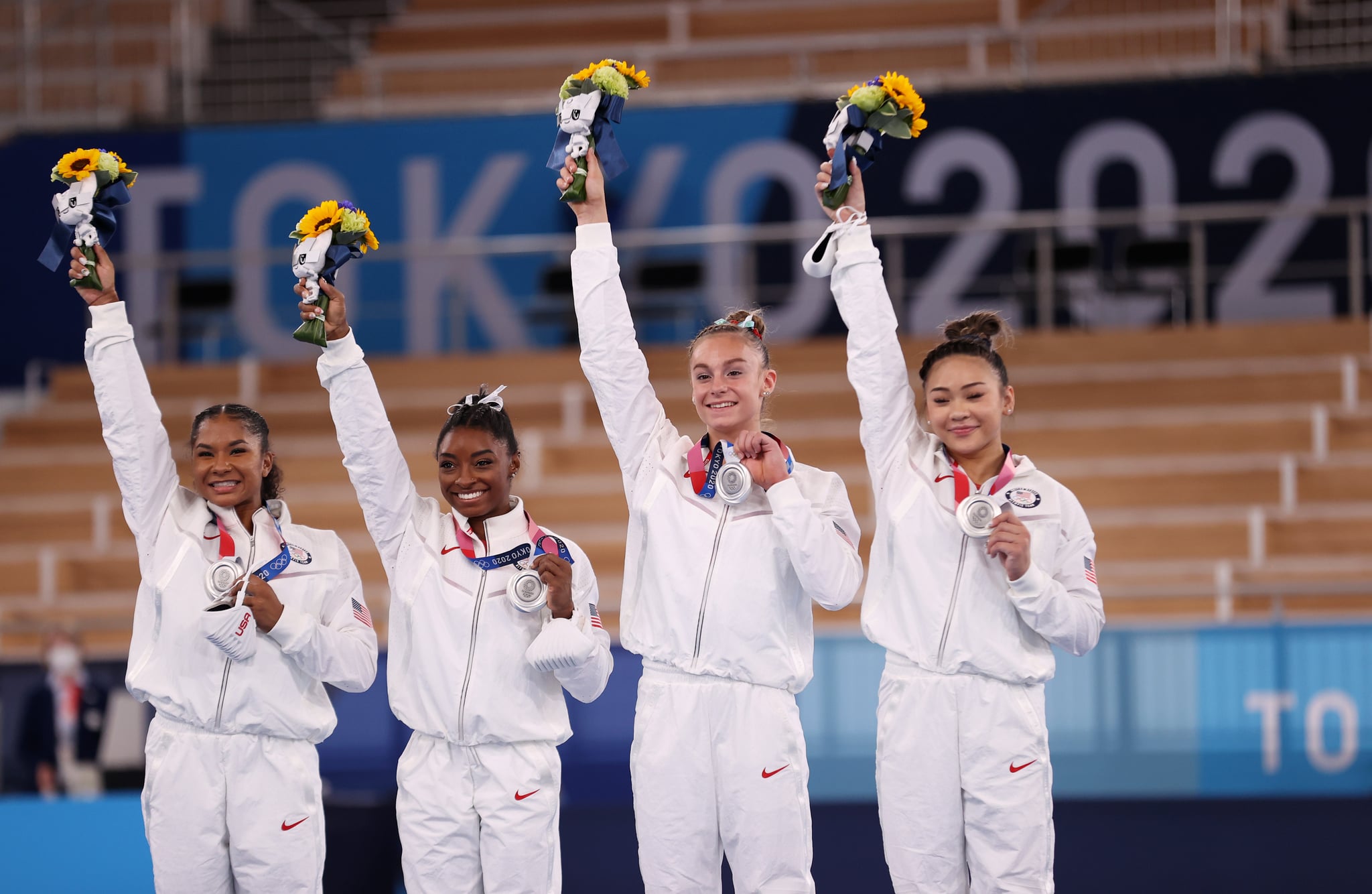 TOKYO, JAPAN - JULY 27: Jordan Chiles, Simone Biles, Grace McCallum and Sunisa Lee of Team United States react on the podium after winning the silver medal during the Women's Team Final on day four of the Tokyo 2020 Olympic Games at Ariake Gymnastics Centre on July 27, 2021 in Tokyo, Japan. (Photo by Laurence Griffiths/Getty Images)
