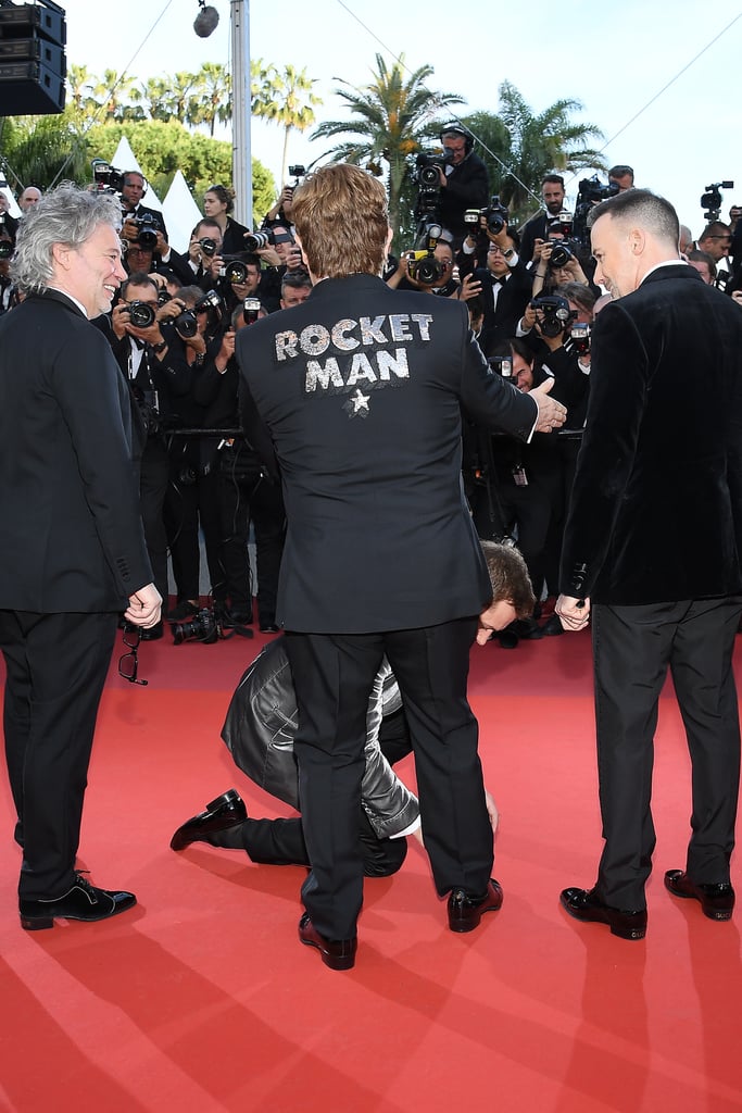 Spectators Make Sure to Appreciate Taron Tying Elton's Shoe From All Angles