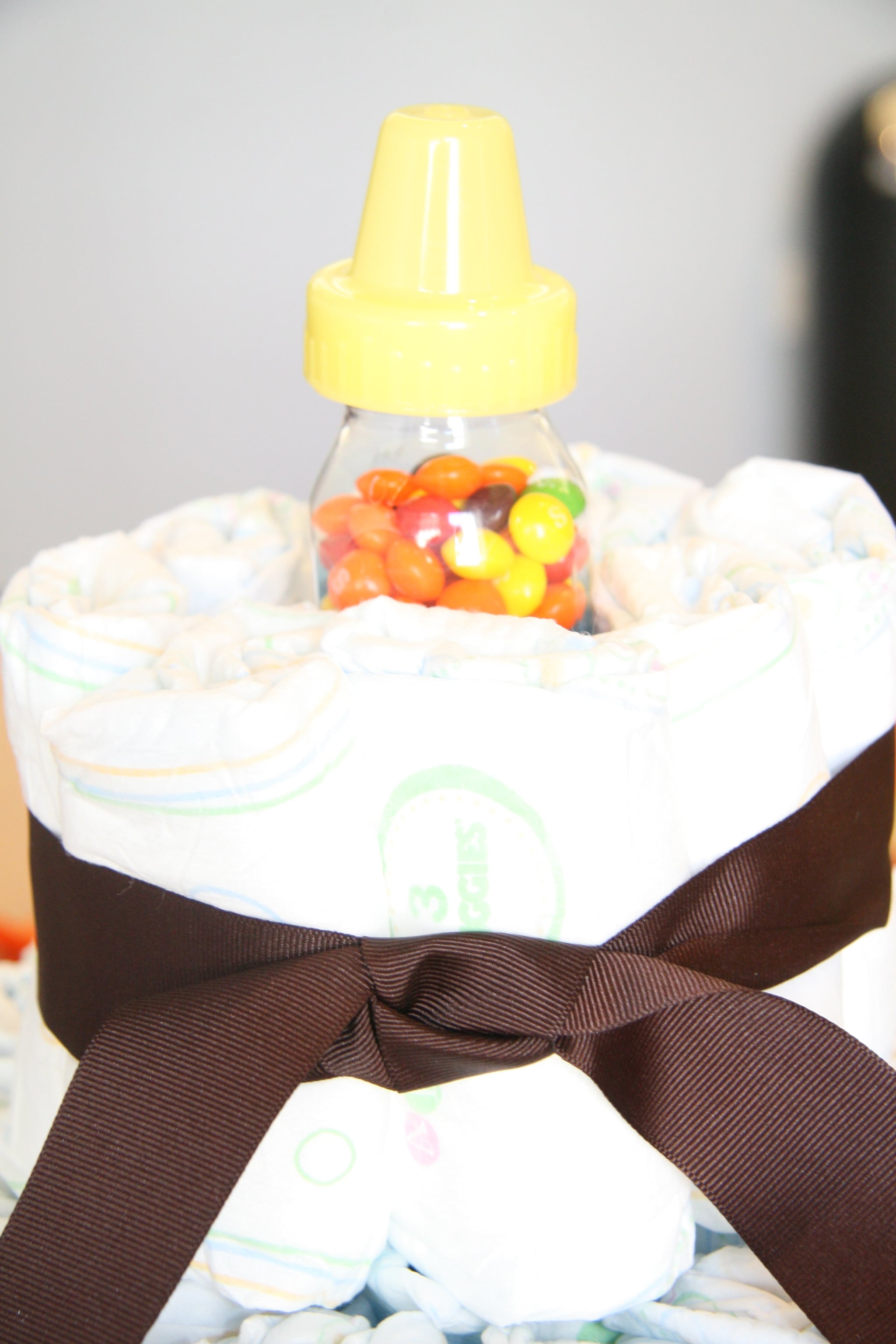 Instead of filling the top layer with diapers, put a candy filled bottle in the center.