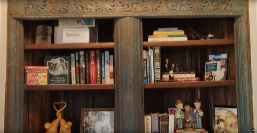 Right outside their room, there's a wooden bookshelf filled with trinkets, photos, and books. Right outside their room, there's a wooden bookshelf filled with trinkets, photos, and books.