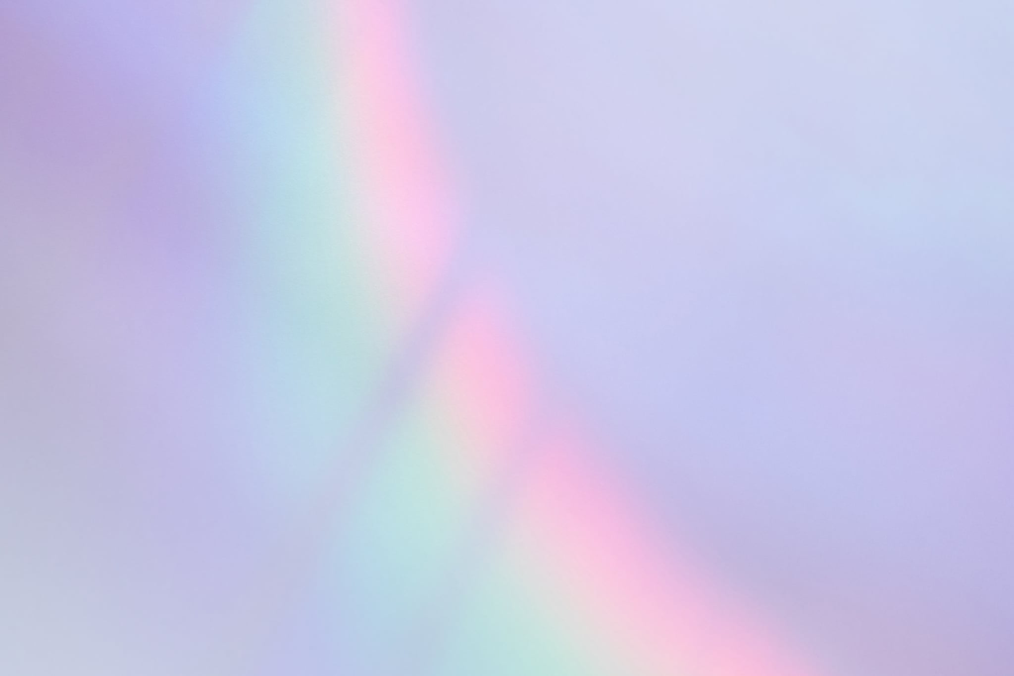 Abstract lavender-colored wall with a shiny iridescent holographic rainbow overlay light effect. Interest in lavender marriage is spiking among Gen Z since the election.