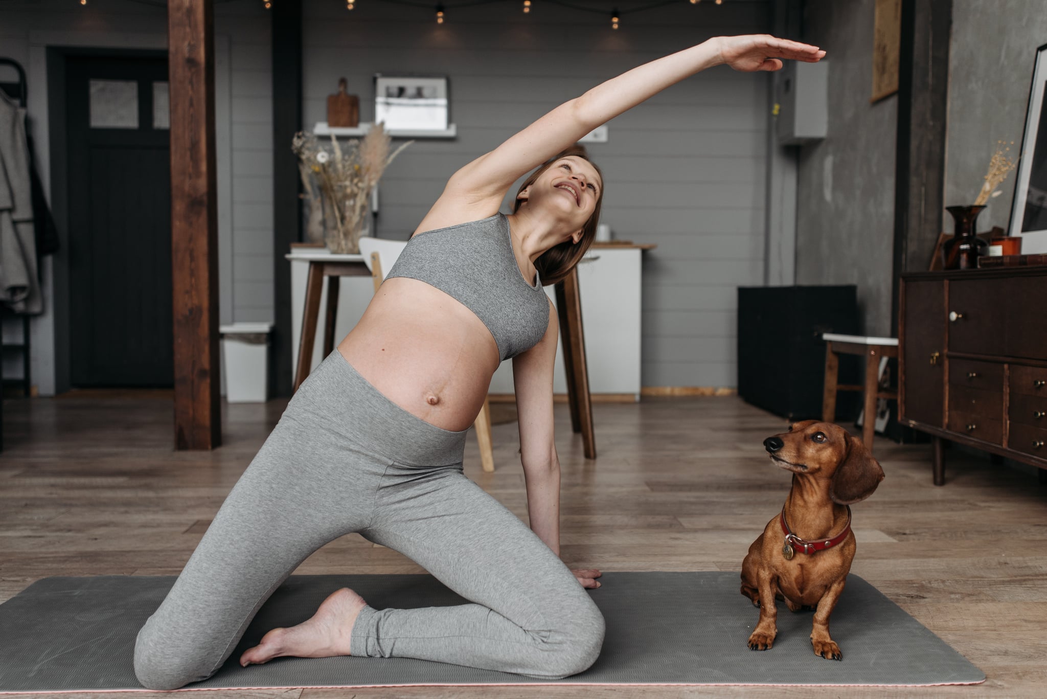 woman doing yoga while pregnant watching her heart rate during pregnancy exercise