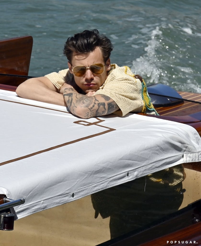 Harry Styles just landed in Italy, and his outfits are already a vacation mood. The "Watermelon Sugar" singer looked like a total vibe in his retro outfit while sitting in a water taxi. He wore two of his go-to brands: Bode and Gucci. He opted for a yellow button shirt that had embroidery of what looked like animals on the back, paired with brown shorts. To complete his look, he wore a pair of gold-trimmed sunglasses, tall socks, and checkered low-top Vans that made the outfit feel more casual.
As he disembarked from the boat, we saw that he also carried a small Gucci suitcase that was so effortlessly cool. His entire outfit screamed, "Tell me you're on an Italian vacation without telling me you're on an Italian vacation." Keep reading to see the pictures and shop out his look. Don't say we didn't warn you if it makes you want to book a flight to Italy ASAP.

    Related:

            
            
                                    
                            

            14 Times Harry Styles Won Over Our Hearts With His Stylish Shoes