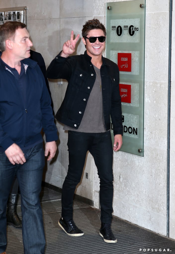 On Thursday, Zac Efron flashed a peace sign while walking around London.