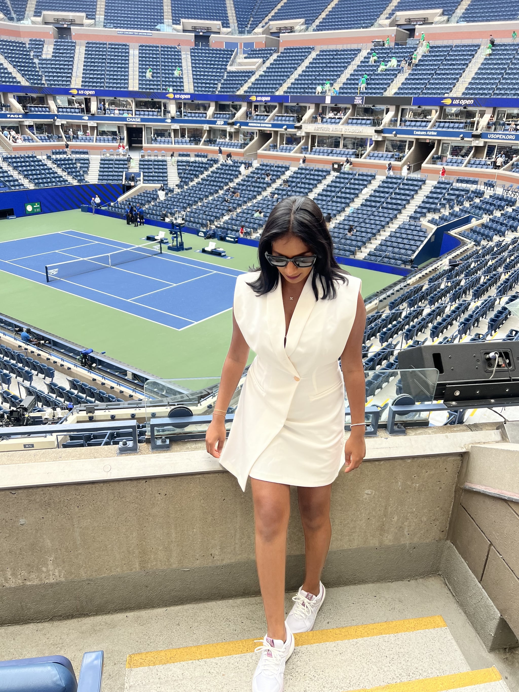 Woman wearing the On Roger Clubhouse Pro Shoes in lavender with a white dress at the US Open.