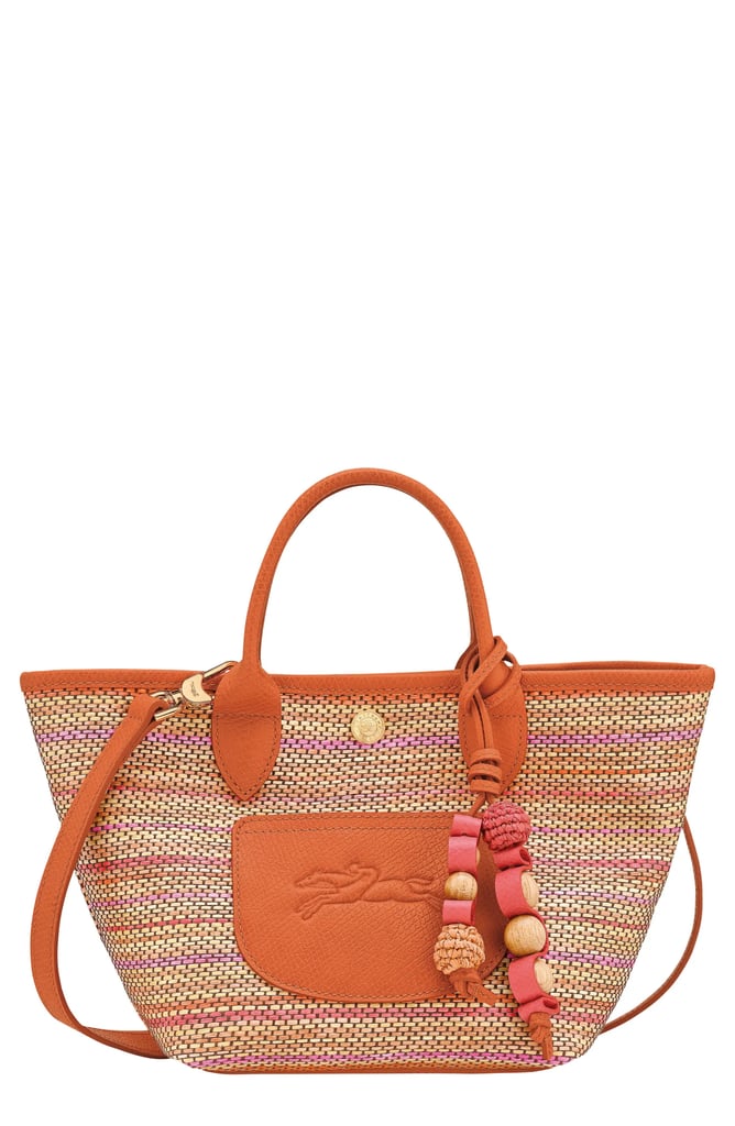 Longchamp Extra Small Le Pilage Panier Rainbow Top Handle Bag ($207, originally $395)
Whether you're looking to add a pop of color to your look or searching for a vibrant summer bag, this mini woven bag is a winner in our books. It can be worn as a crossbody or as a top handle bag, depending on your preference. Plus, the adorable woven charms feel especially trendy.