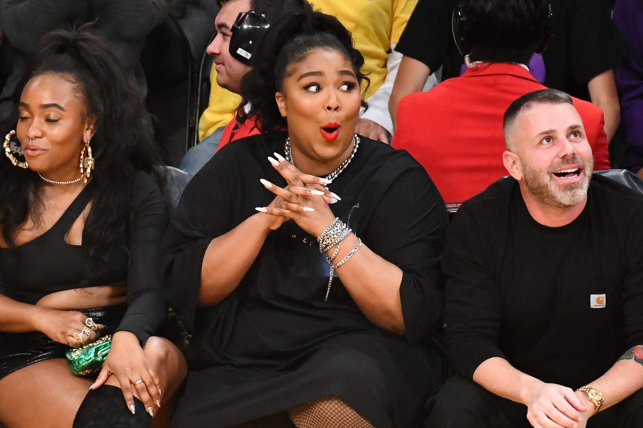 LOS ANGELES, CALIFORNIA - DECEMBER 08: Singer Lizzo (C) attends a basketball game between the Los Angeles Lakers and the Minnesota Timberwolves at Staples Centre on December 08, 2019 in Los Angeles, California. (Photo by Allen Berezovsky/Getty Images)