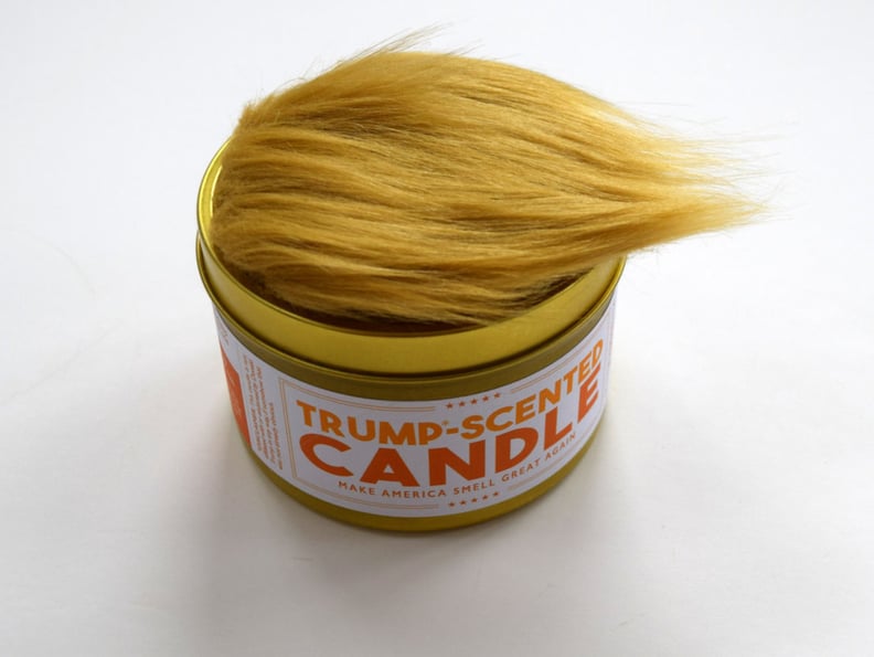The Candle Features a Cluster of Fake Hair on Top