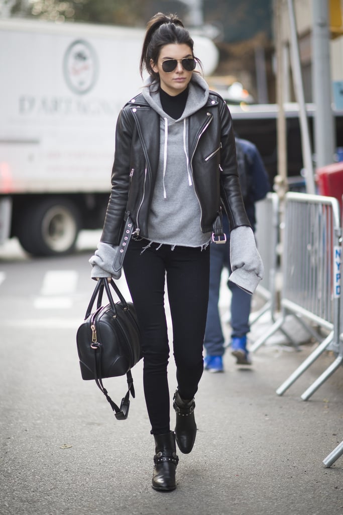 Kendall Jenner arrived at the show in an edgy yet casual street style look that included a frayed gray sweatshirt, leather jacket, and Paige black skinny jeans.