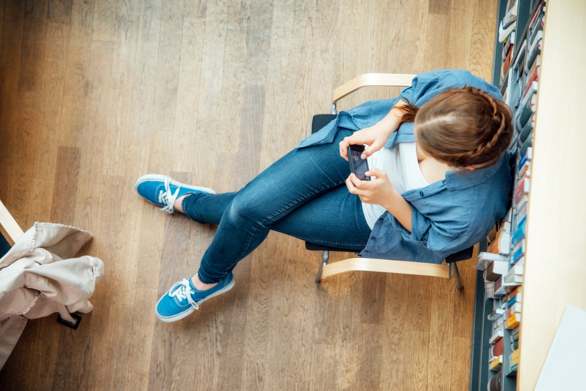 Woman sitting with legs crossed.