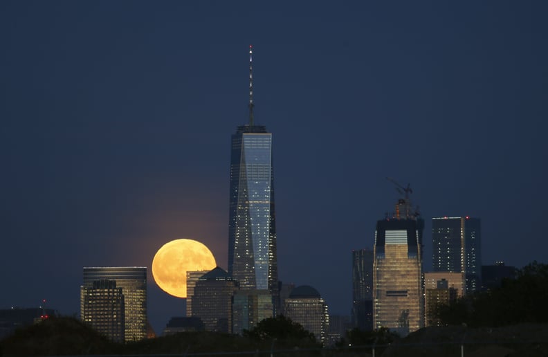 NEWARK, NJ - SEPTEMBER 16: A full harvest moon rises behind Lower Manhattan and One World Trade Center in New York City on September 16, 2016 as seen from Newark, NJ. (Photo by Gary Hershorn/Getty Images)