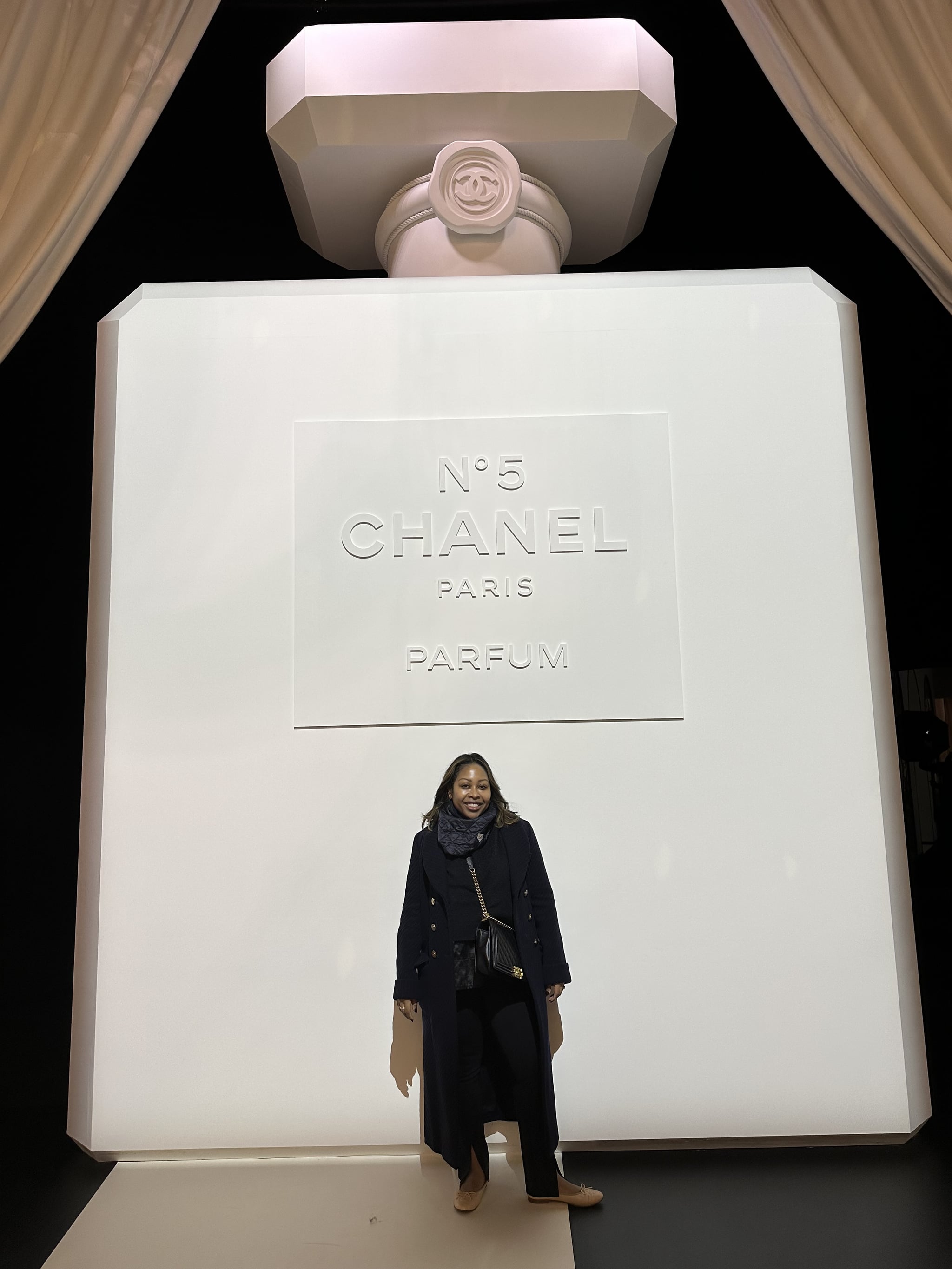 Sade Strehkle in front of Chanel No. 5 display in Paris.