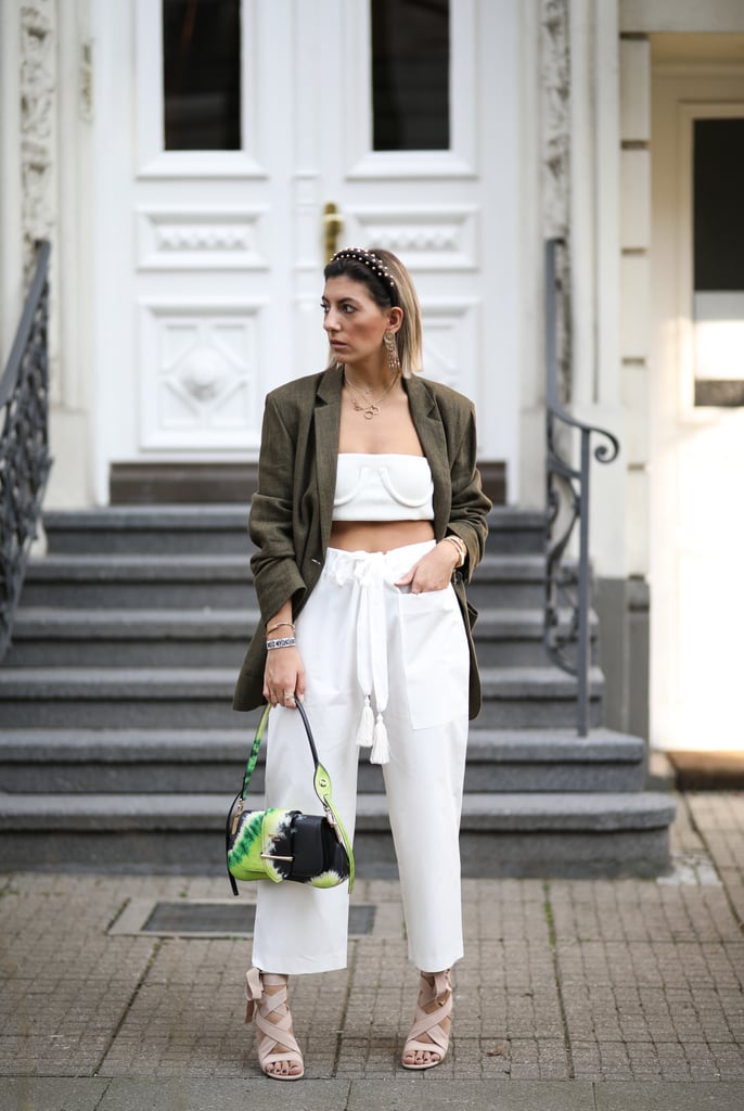 Style a white crop top with matching pants and a green blazer.