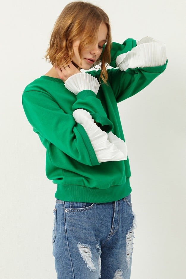 "For me, March is a weird in-between time when it comes to the weather. The sun is shining, but there are days I like to stay warm and cozy too. This Storets cutout sweatshirt with frills ($88) speaks to the transitional season, and I'd absolutely style it with my boyfriend jeans and loafers." — Sarah Wasilak, editor, Fashion