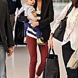 Red pants, stripes, and a sleek blazer make the sophisticated of travel looks.