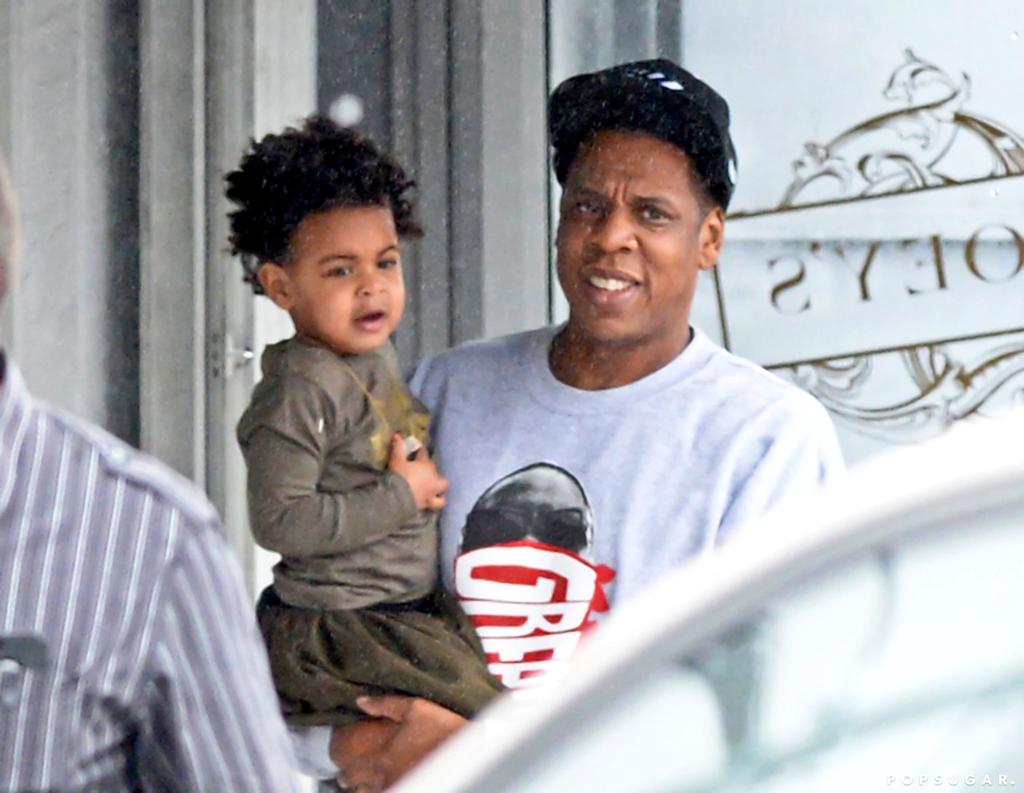 Jay Z held his daughter, Blue Ivy, while Beyoncé followed behind