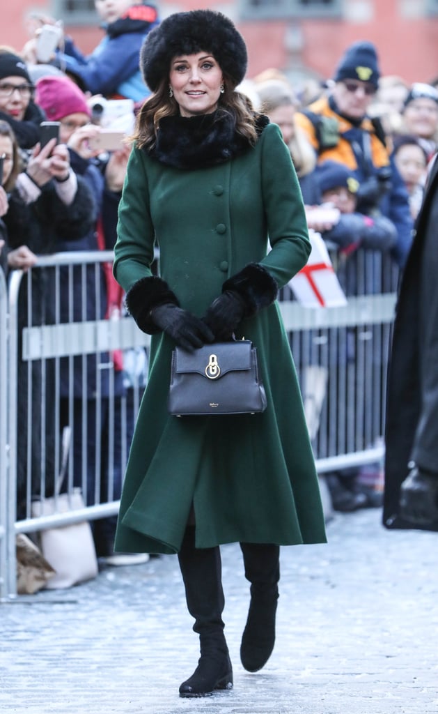 In January, the Duchess of Cambridge walked the cobbled streets of Stockholm in a forest green Catherine Walker coat, Russell & Bromley boots. She carried a black Mulberry Mini Seaton bag.