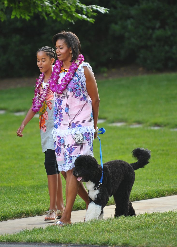 Walking Bo while looking supremely cool dressed for a White House luau in 2009.