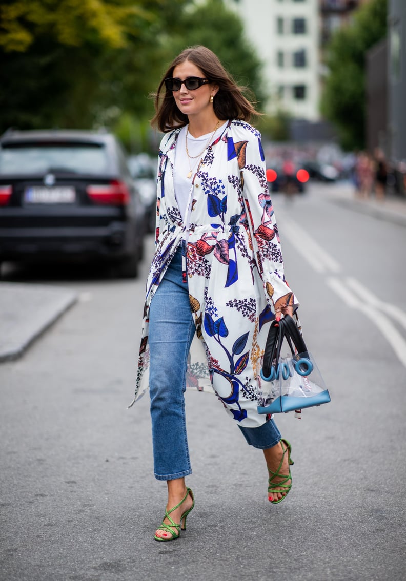 With a Printed Trench Coat, Colorful Sandals, and a Perspex Bag
