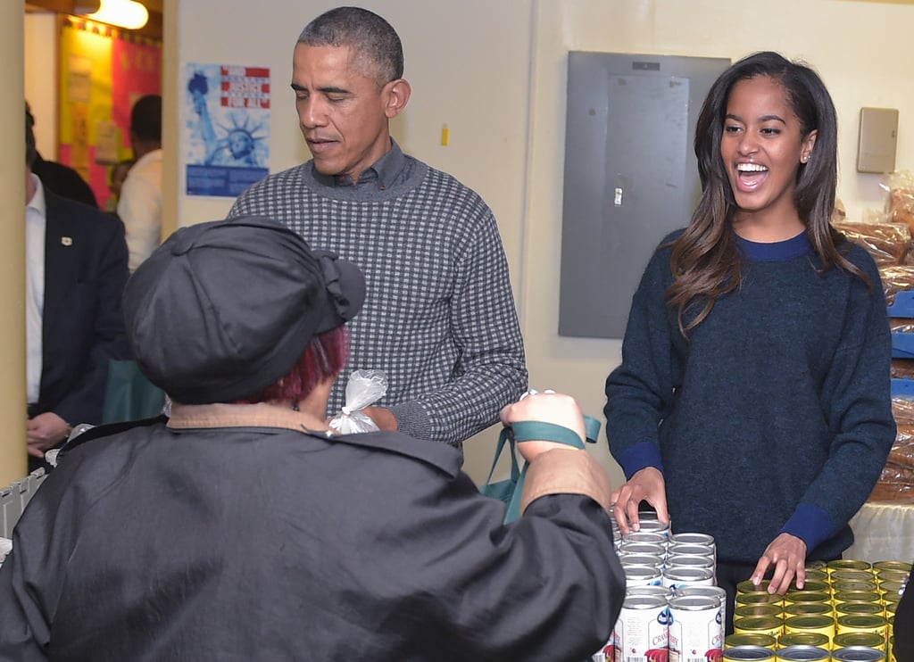 Malia smiled alongside her dad while distributing food at a Bread For the City event in November.