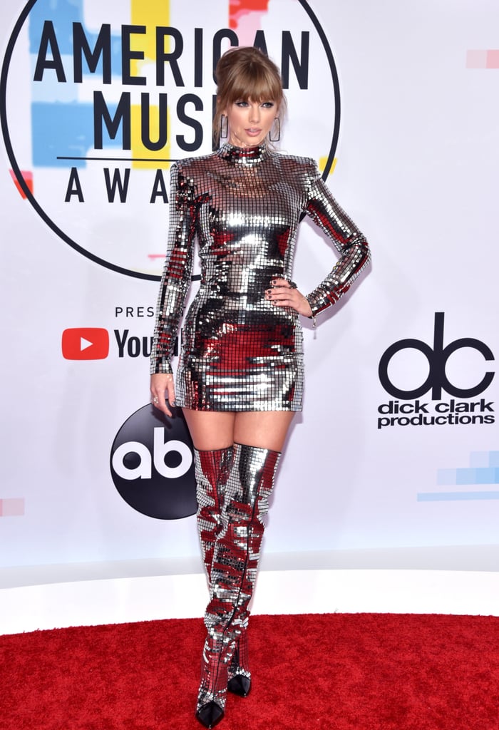 Taylor Swift nearly blinded us when she hit the red carpet in a silver minidress and matching boots at the American Music Awards in LA on Tuesday night. The singer . Taylor â who is nominated for four awards â is scheduled to open the show tonight with her hit "I Did Something Bad," marking her first time hitting the AMAs stage since 2014. 
Over the weekend, Taylor grabbed headlines when she finally broke her political silence on Instagram. Despite her previous decision to keep her political views private, Taylor shared a post on social media about who she plans to vote for in the upcoming midterm elections. "In the past I've been reluctant to publicly voice my political opinions, but due to several events in my life and in the world in the past two years, I feel very differently about that now," she wrote. Naturally, the internet had a meltdown. Will Taylor make another political statement at the AMAs? Guess we'll just have to wait and see.  
Related:
When Did Taylor Swift and Joe Alwyn Really Start Dating? The Answer Might Surprise You
