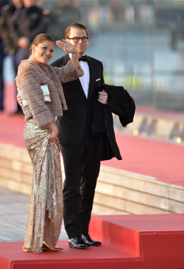 Crown Princess Victoria of Sweden wearing a furry coat and sequined gown.