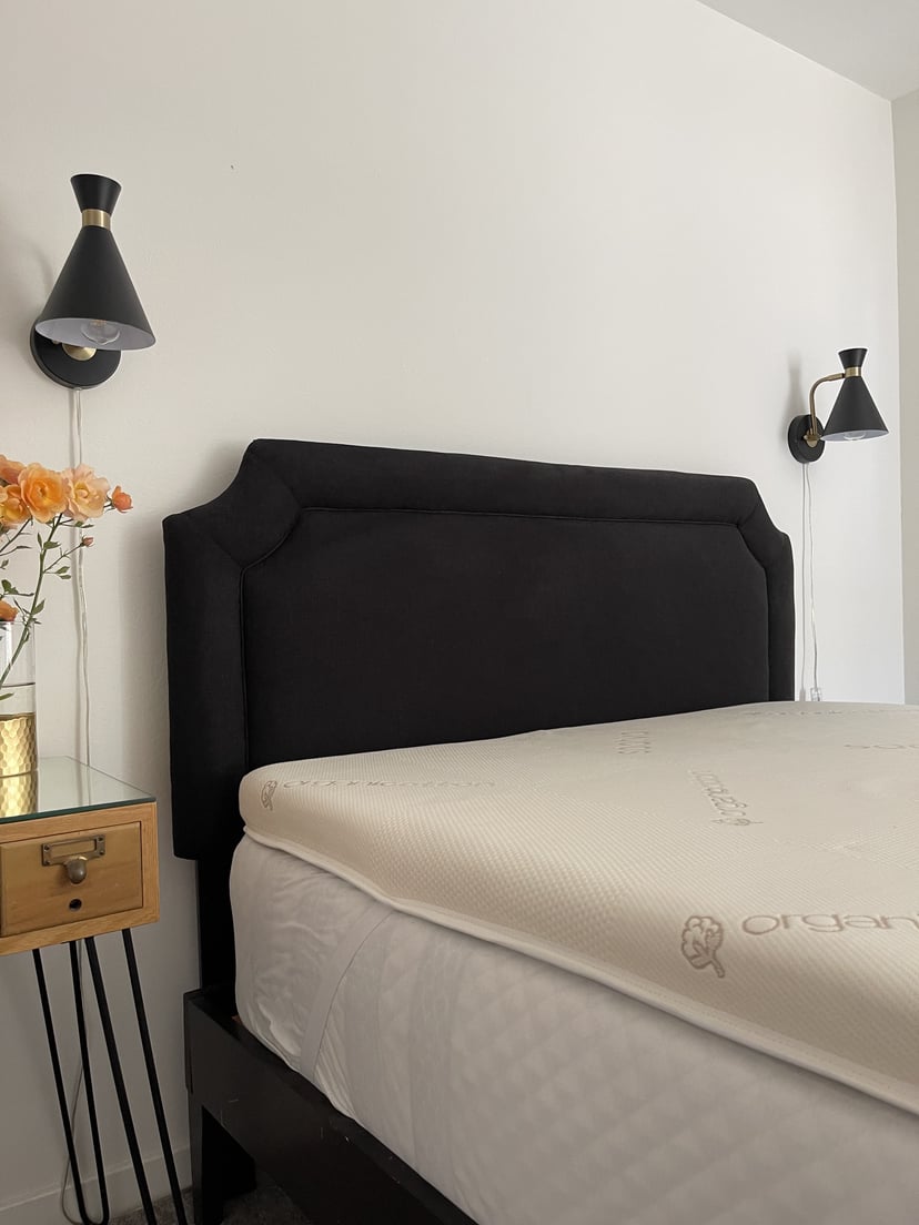 Saatva Graphite Memory Foam Topper on top of a mattress