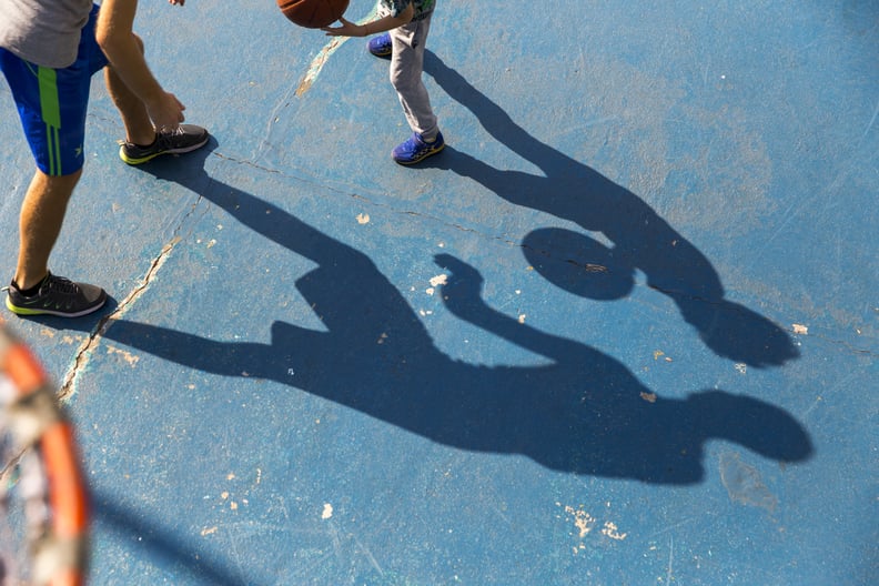 shadows of father and son playing basketball