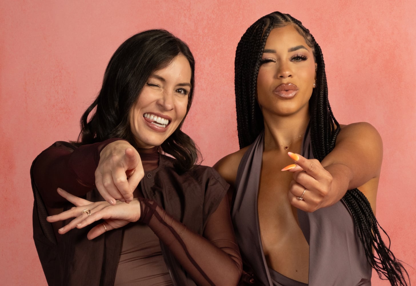 Popsugar Editor-in-Chief Kelsey Castanon winks and smiles standing next to Amaya Papaya Espinal, who is winking and snapping her fingers.