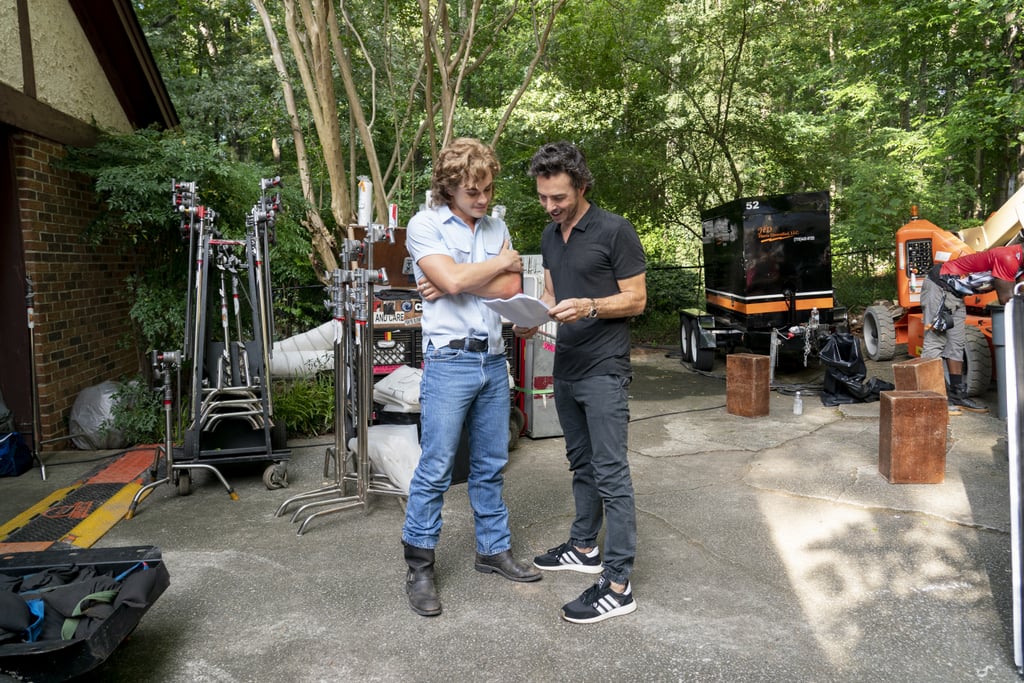 Dacre Montgomery and his mullet go over a script with Shawn Levy.