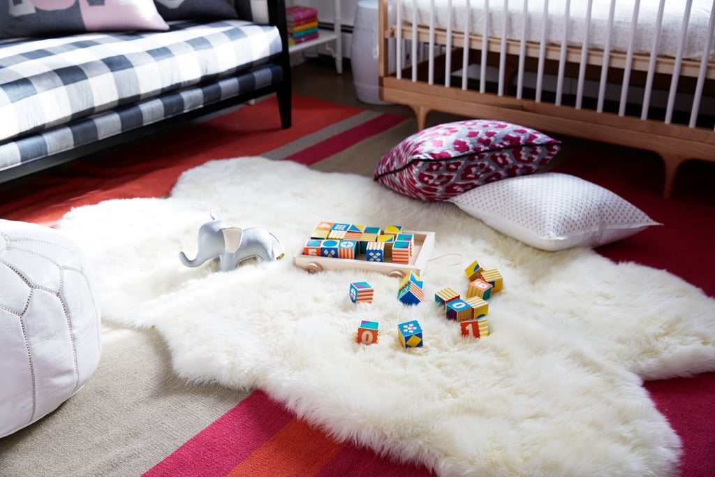 To create a soft, warm feeling, a Mongolian sheepskin, perfect for a bit of tummy time, was layered on top of a burnt-orange-and-fuchsia dhurrie.