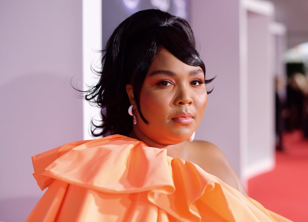 Lizzo dominated the red carpet at the American Music Awards on Sunday. The 31-year-old shone bright in an orange one-shoulder gown with cascading ruffles. She completed the look with heels, glimmering silver nails, and a teeny-tiny Valentino purse. Lizzo was up for three awards: new artist of the year, favorite soul/R&B female artist, and favorite soul/R&B song for her hit "Juice." She also took the stage for her first-ever AMAs performance, where she debuted her new single, "Jerome." 
Prior to taking the stage, Lizzo gave an interview on the red carpet, saying, "I just want people to feel good." "My music is like the definition of feel-good music," she added. "We all go through it . . . and I feel like my music just helps people get through the bullsh*t." Look ahead to see all the photos from Lizzo's exciting evening, which included hanging out with Lil Nas X and will.i.am. 

    Related:

            
            
                                    
                            

            17 Lizzo Quotes That Prove She&apos;s the Hero We All Need but Don&apos;t Deserve