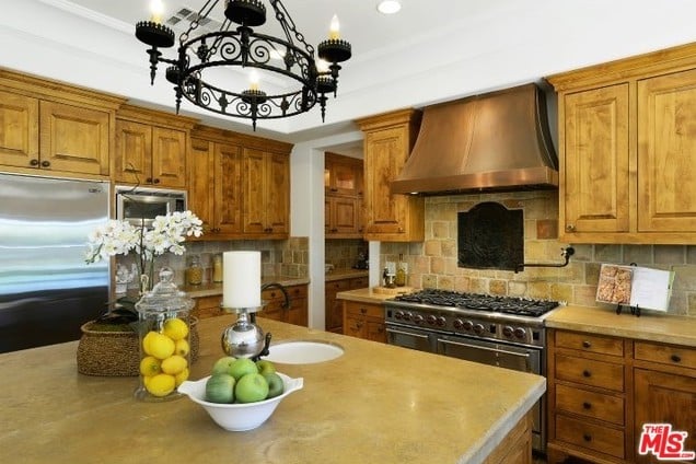Decorated in warm, rustic wood, the chef's kitchen features top-of-the-line appliances.