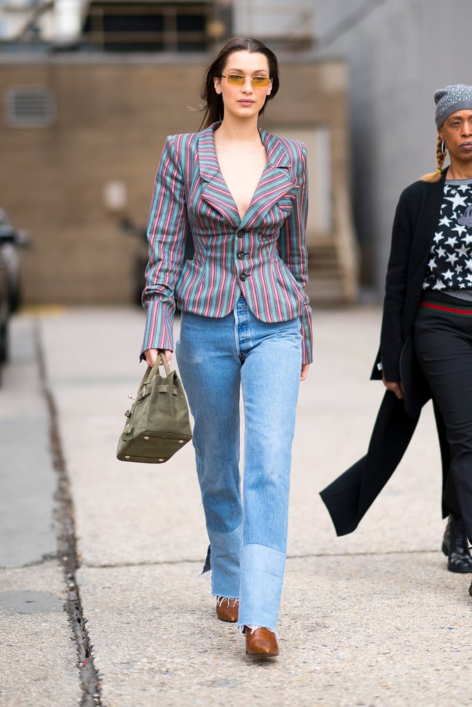 Wearing a striped blazer by Vivienne Westwood with Re/Done jeans and a suede Birkin bag.