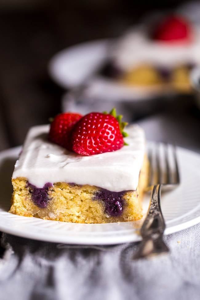 Paleo Poke Cake With Strawberries, Blueberries, and Coconut Cream