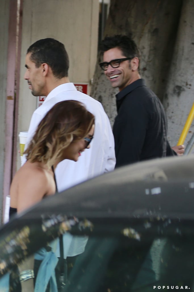 Vanessa Hudgens and John Stamos smiled when they spotted each other at the salon valet in LA on Friday.