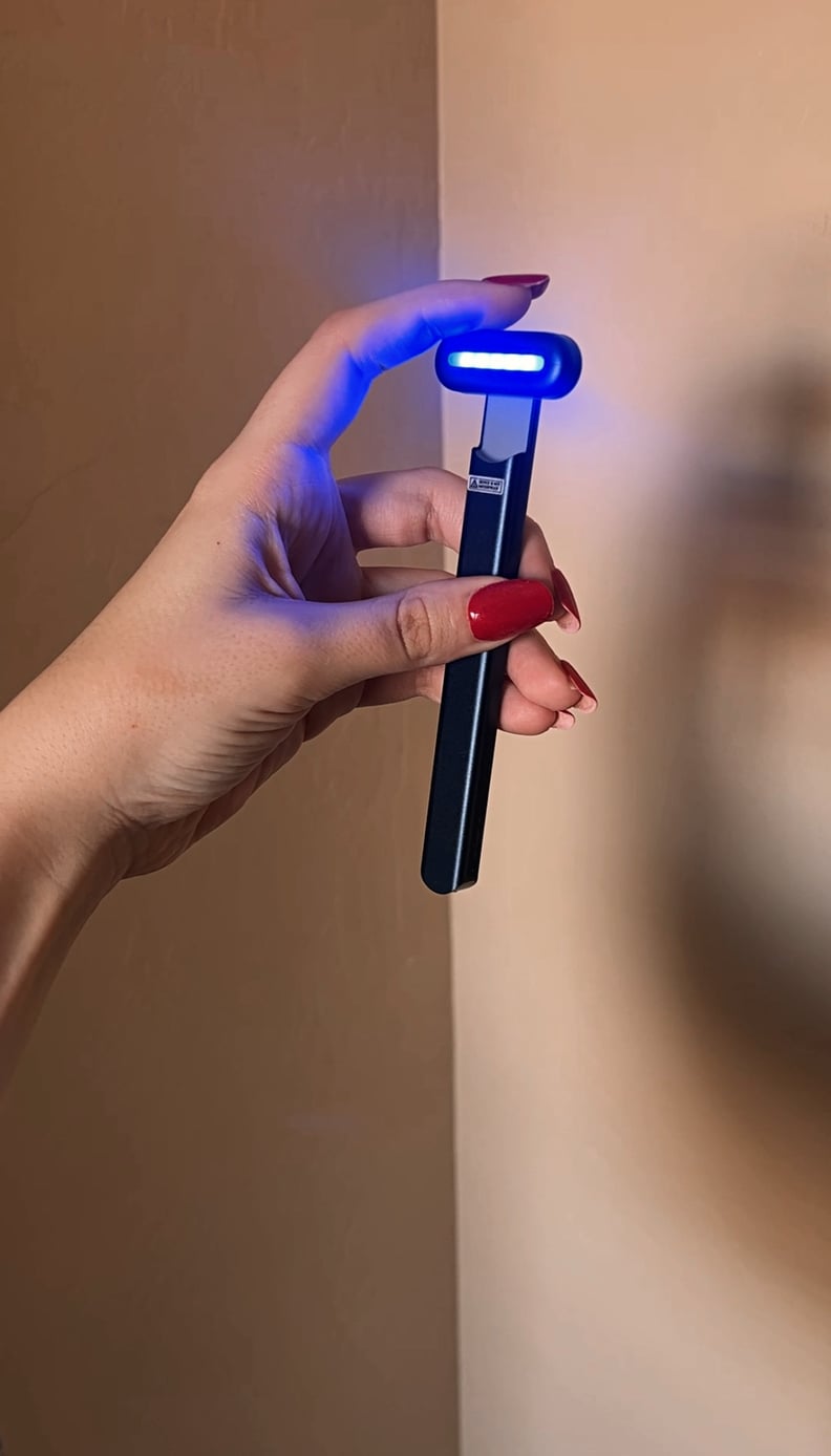 woman holding Solawave Blue Light Therapy Wand