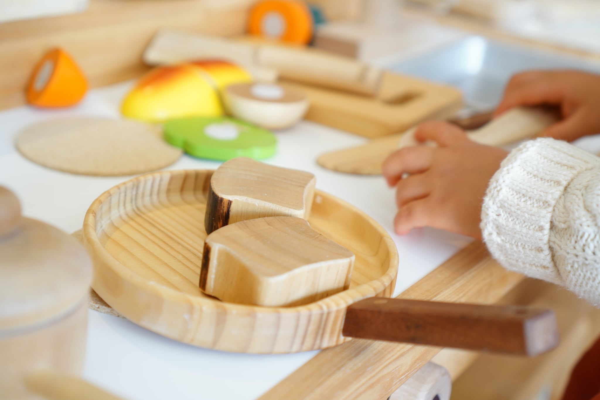 A child is playing with wooden toys.