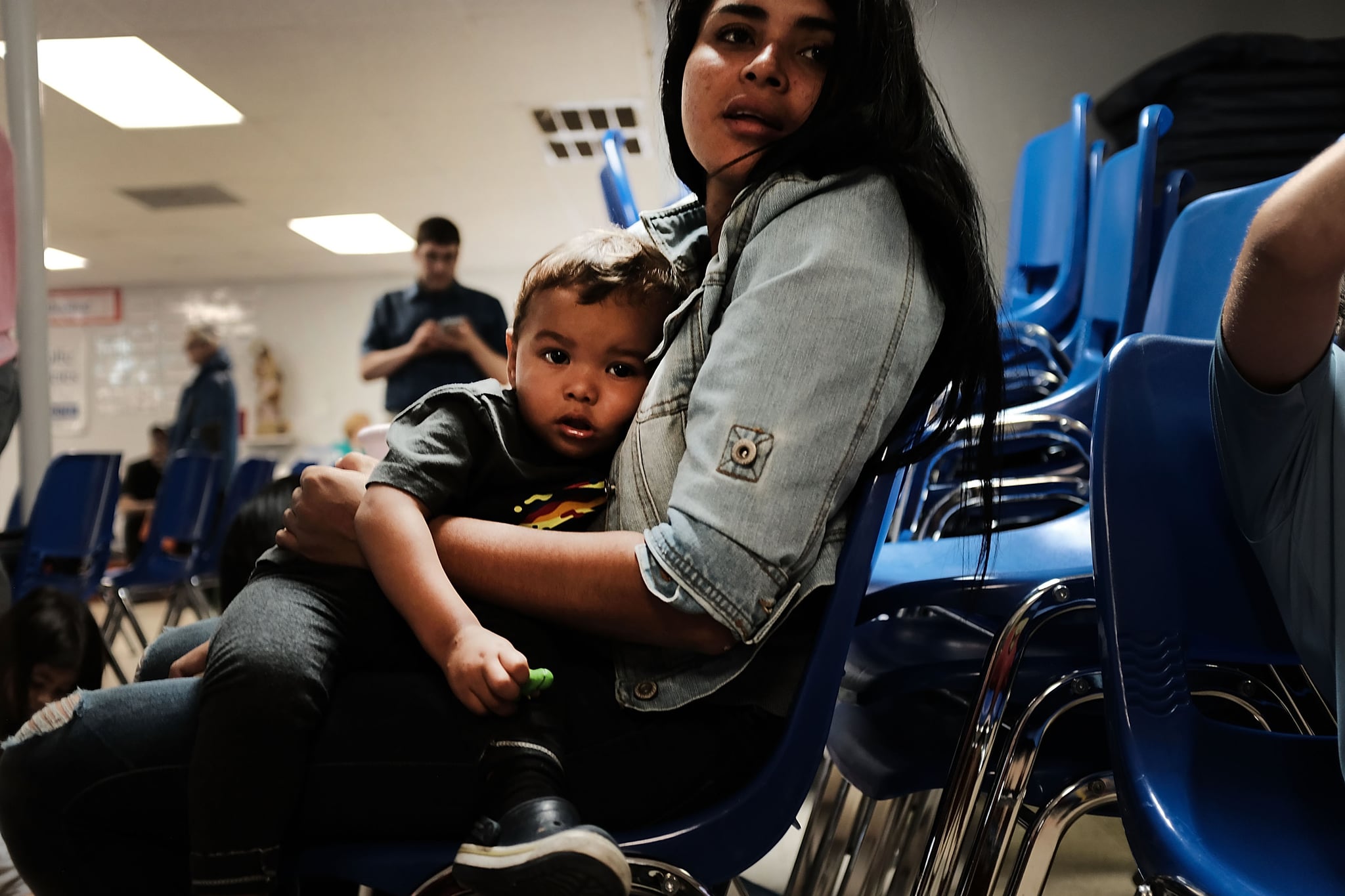 MCALLEN, TX - JUNE 21: A woman who idendtified herself as Jennifer sits with her son Jaydan at the Catholic Charities Humanitarian Respite Centre after recently crossing the U.S., Mexico border on June 21, 2018 in McAllen, Texas. Once families and individuals are released from Customs and Border Protection to continue their legal process, they are brought to the centre to rest, clean up, enjoy a meal and get guidance to their next destination. Before Trump signed an executive order yesterday that the administration says halts the practice of separating families seeking asylum, more than 2,300 immigrant children had been separated from their parents in the  zero-tolerance policy for border crossers. (Photo by Spencer Platt/Getty Images)