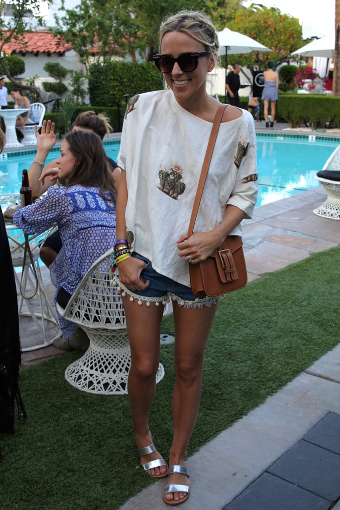 Jacey Duprie worked her neutral-print Creatures of Comfort top with pom-pom-embellished Pac Sun shorts, a neutral YSL bag, and metallic sliders from J.Crew.