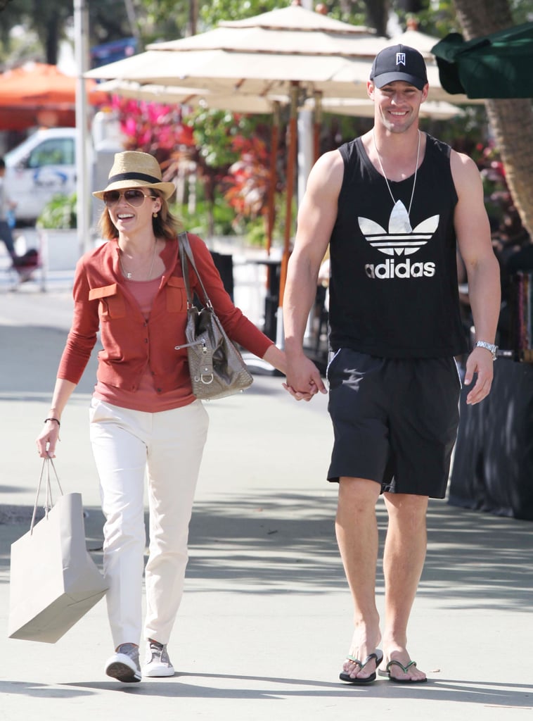 Dannii Minogue and Kris Smith held hands as they shopped in Miami yesterday. During her stay Stateside Dannii's been hard at work shooting Marks and Spencer ads in her swimsuit alongside fellow models Twiggy, VV Brown, Ana Beatrix Barros and Lisa Snowdon. She's now enjoying some time off and chose to visit the shops wearing a cute "E" necklace", while Lisa hit the beach in her bikini. Dannii and Kris arrived in Miami last week, and will no doubt be looking forward to getting back to family time with Ethan Down Under.