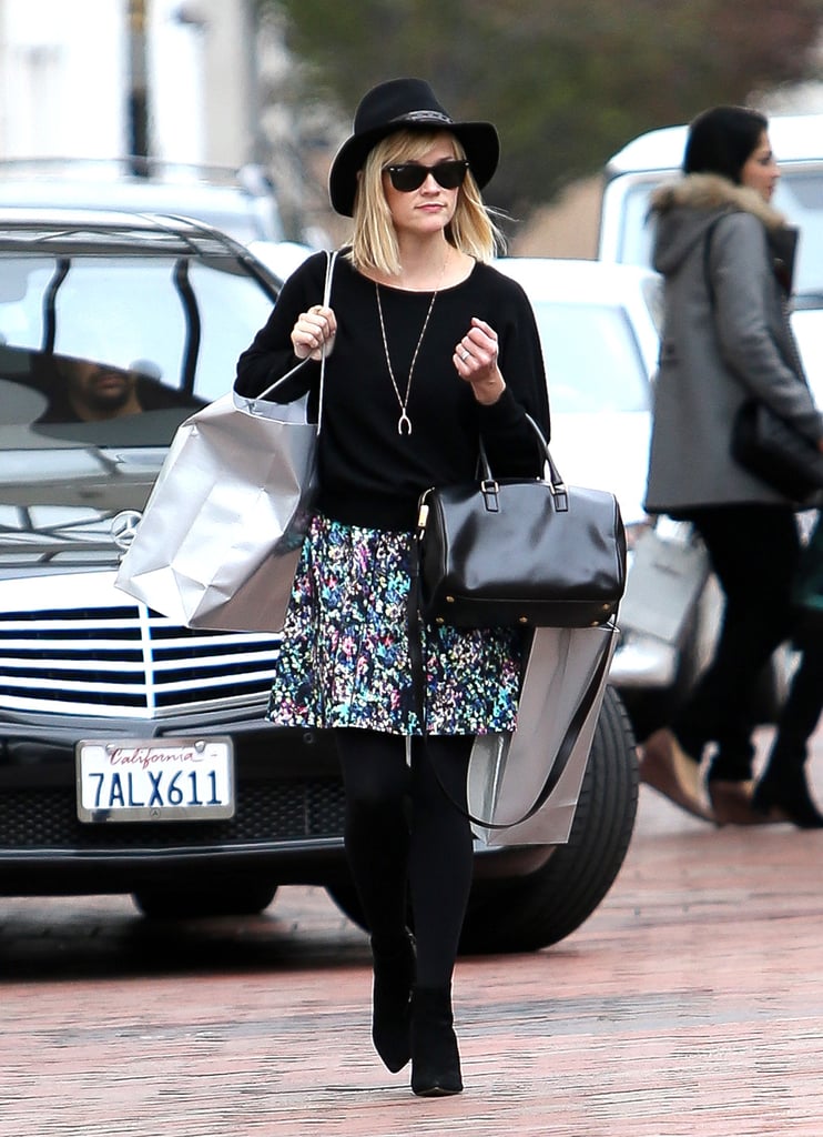 Reese broke up her all-black palette with a floral skirt while shopping in LA.