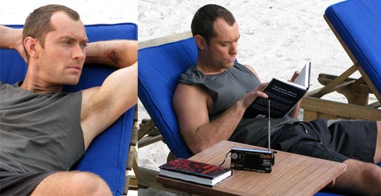 Jude Law Reading On The Beach Popsugar Celebrity